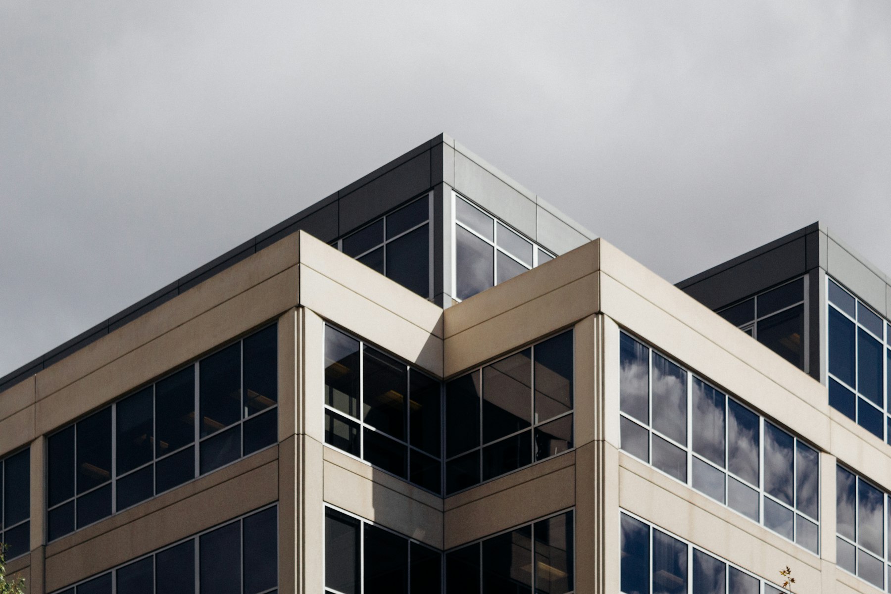 Esquina superior de un edificio de oficinas de líneas rectas y ventanales continuos
